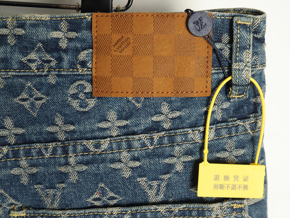 Louis Vuitton washed blue jeans with all-over print and side straps
