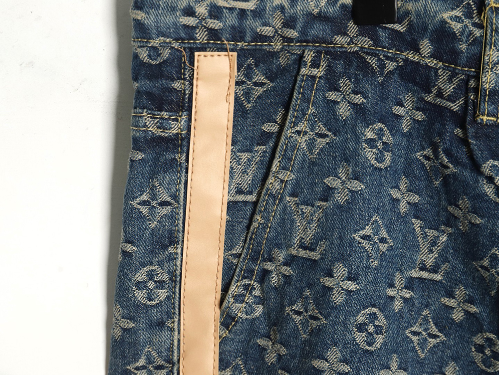 Louis Vuitton washed blue jeans with all-over print and side straps
