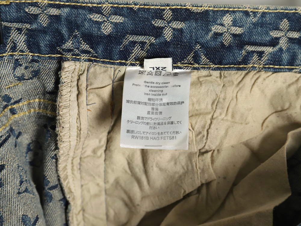 Louis Vuitton washed blue jeans with all-over print and side straps